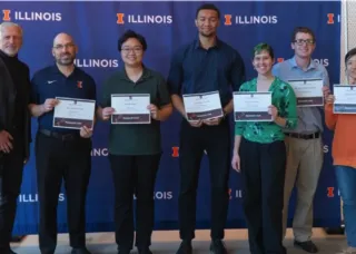 People holding certificates smiling